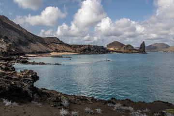 Beautiful coastline with rocky limestone mountains, blue water, blue sky and puffy white clouds