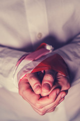 Female hands tied with stop tape, closeup. Coronavirus epidemic, influenza virus quarantine concept - bound hands on black background