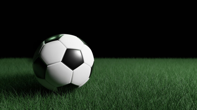 Classic soccer ball on the green field with a black background.3d rendering.