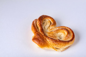sweet bun with icing sugar on top isolated on white background, close view 