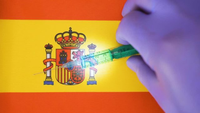 Putting the small syringe near the logo of the Spain flag