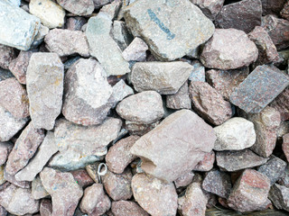 Cliff stone big and small located part of the mountain rock on floor.Texture rock material surface background.