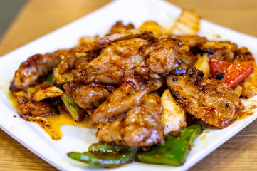 Delicious Chinese Stir Fried Pork in a White Plate