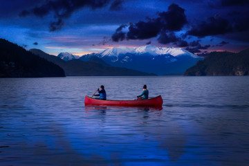 Fantasy Image Composite of Adventurous People on a Wooden Red Canoe during a Blue Twilight Hour. Landscape from Harrison Lake, British Columbia, Canada.
