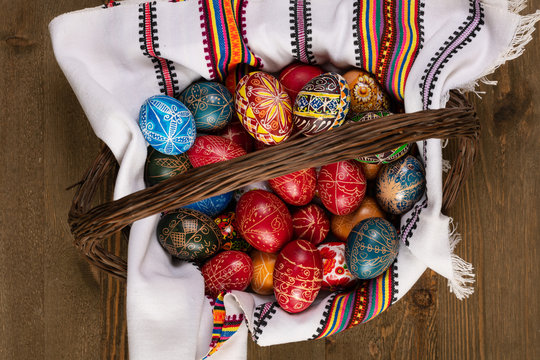 Set of Easter eggs painted in traditional Eastern European style with a floral/geometric design in a basket.