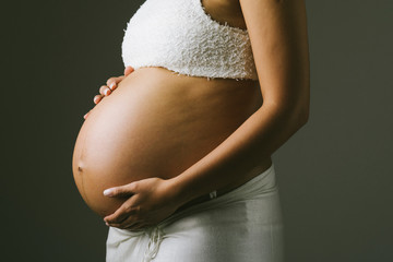 Pregnant woman touching her belly