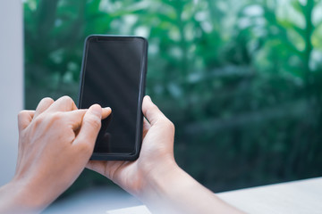 Woman hand use smartphone to do work business, social network, communication in public.