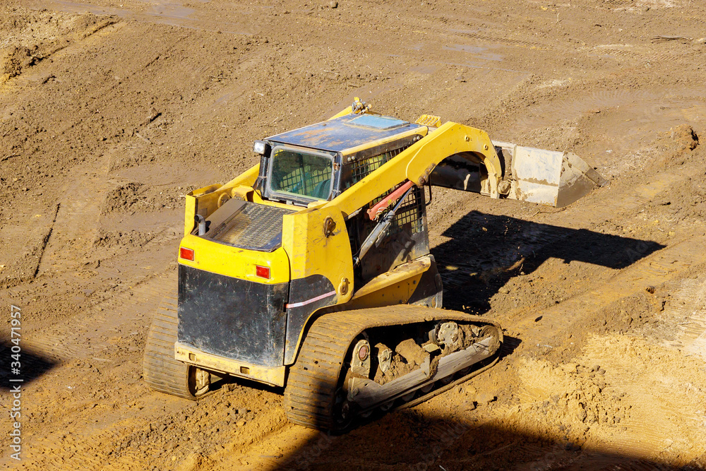 Wall mural The bulldozer moves soil construction equipment digging ground