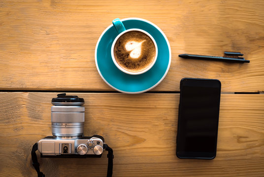 Vacation planning, travel with your favorite cell phone and camera, and good coffee close by with black pen, vintage picture.