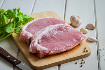 Raw pork meat on wooden board