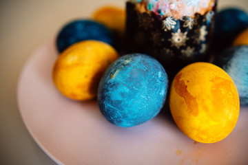 colored eggs and Easter cake on a plate