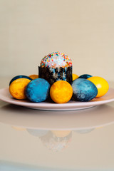 colored eggs and Easter cake on a plate