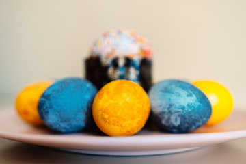 colored eggs and Easter cake on a plate