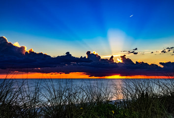 sunset over the beach, sky, lake, water, sunbeam, sun, beautiful, rays, clouds, horizon, blue, yellow, dusk