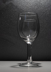 glass of wine one in front of the other in black and white