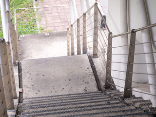 the building staircase for descending from footbridge.