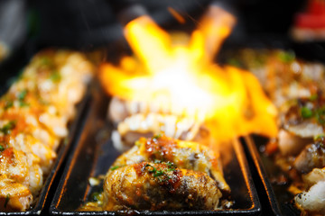 Close up hand of Japanese chef using kitchen torch burn sushi