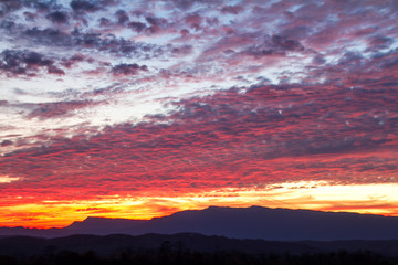colorful clouds over mountain on sunset