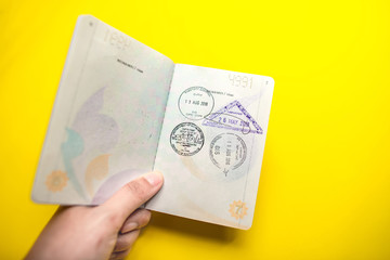 immigration stamps on passport and Thai passport with Plane economy ticket background.