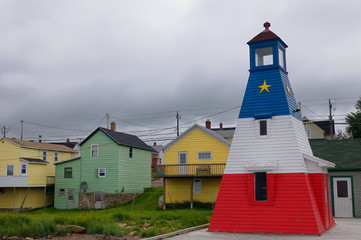 Cheticamp lighthouse and clapboard houses on Cape Breton Island Nova Scotia