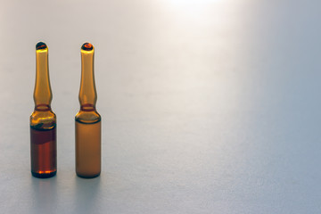 two closed ampules isolated on white