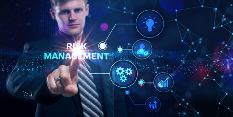 Business, Technology, Internet and network concept. Young businessman shows the word on the virtual display of the future: Risk management