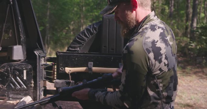 Man hunting in woods with rifle