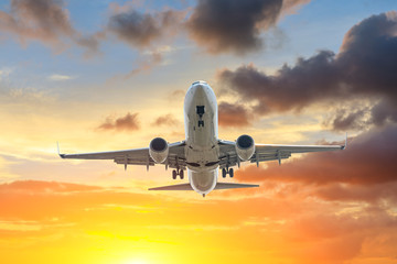 Fototapeta na wymiar Commercial airplane flying in beautiful sky at sunset,travel concept.