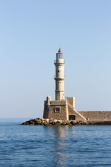 The old lighthouse guarding the entrance to the old Venetian harbour in Chania, Crete, Greece