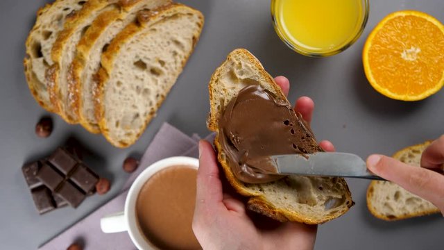 woman preparing slice of bread for breakfast