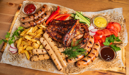 meat plate with sauces and french fries