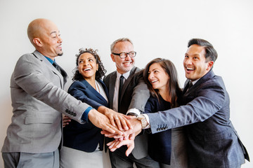 Team of business people stacking hands