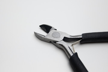 Wire cutters for cutting electrical cable. Close up on white background. Black handles.