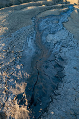 mud volcano and mud lava coming out of the crater