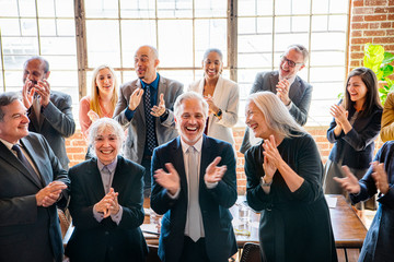 Team of business people clapping