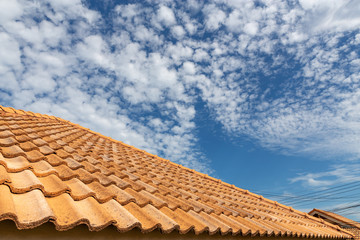 Obraz premium Close up of brown clay roof tiles. Red old dirty roof. Old roof tiles. Construction equipment build a house.