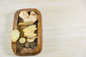 Ginger root (Zingiber officinale) on light and woody background