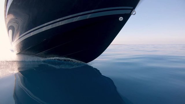 View of a motorboat front while floating on crystal clear blue ocean 