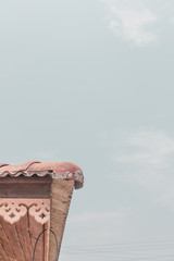 The roof of a home  on a minimalistic sky background.
