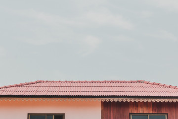 The roof of a home  on a minimalistic sky background.