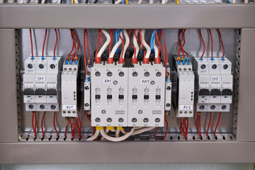 Two contactors with mechanical interlocking between them, two phase control relays and two circuit...