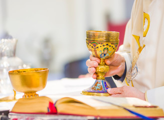 chalice with wine, blood of christ, and pyx with bread, body of christ, ready for the communion of the faithful