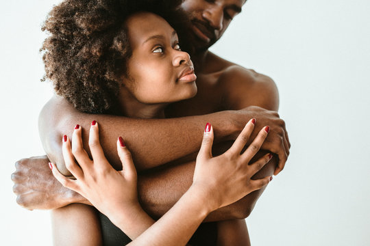 Shirtless black man embracing his girl