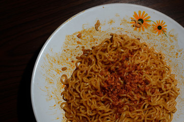 Indonesian fried instant noodles. fried noodles on a plate taken with low light. dark