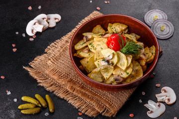 Rustic potato wedges with cheese, herbs and tomato sauce on black background