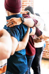Team holding around each other