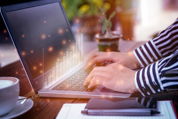 Business woman use notebook ,analytics and financial concept, chart from computer notebook ,Business growth concept.