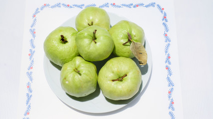 Guava fruits in plate on white background
