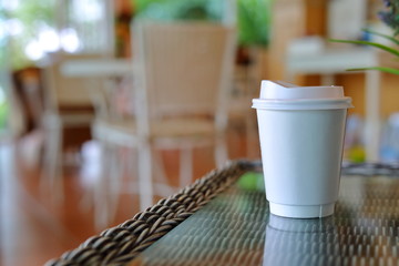 take away cup for hot coffee drink put on glass table in cafe shop