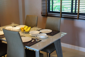 dish ware sets arrange on dining table inside eating room of modern home interior